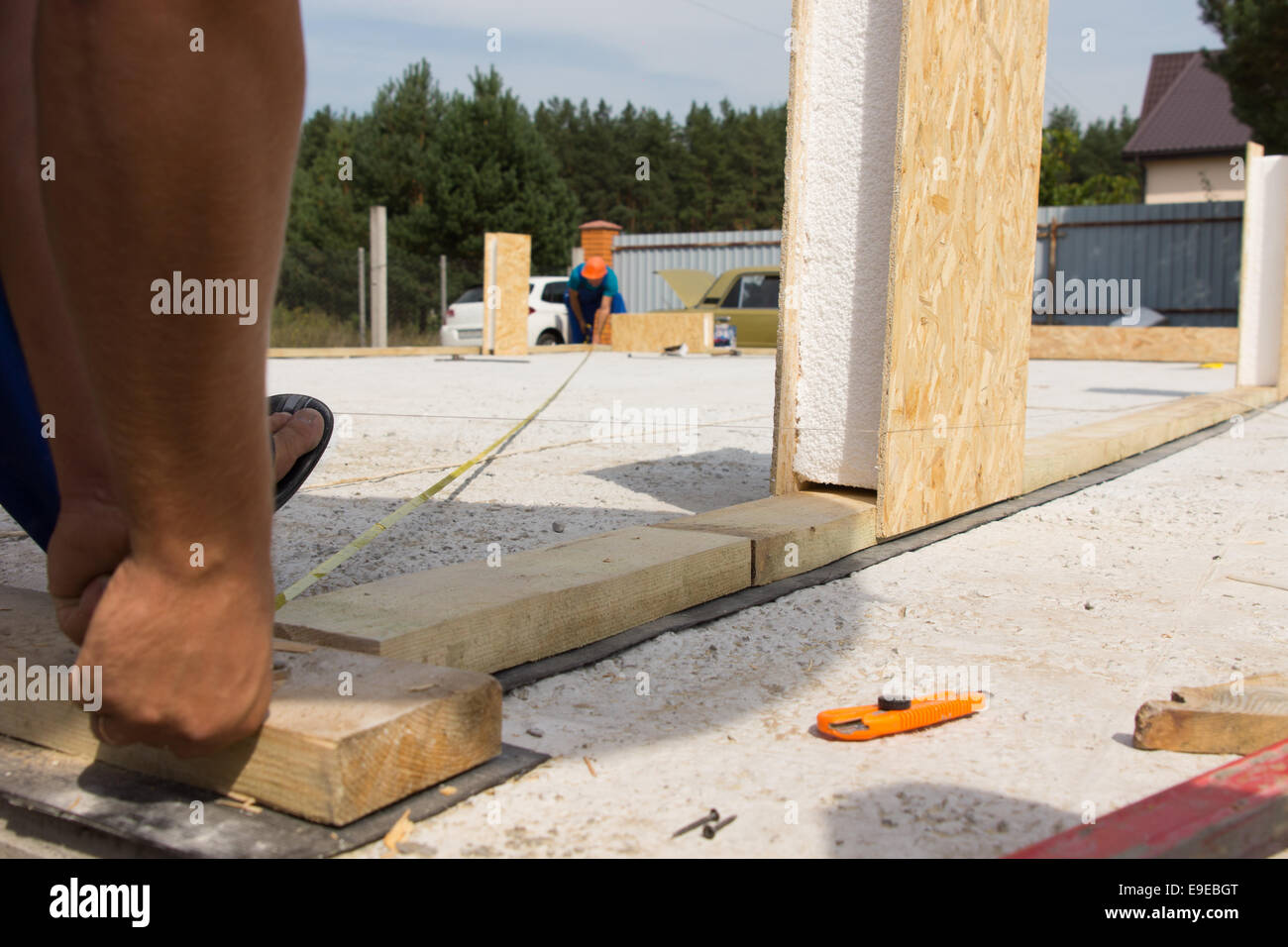 Low angle view at floor level from behind of two workmen taking