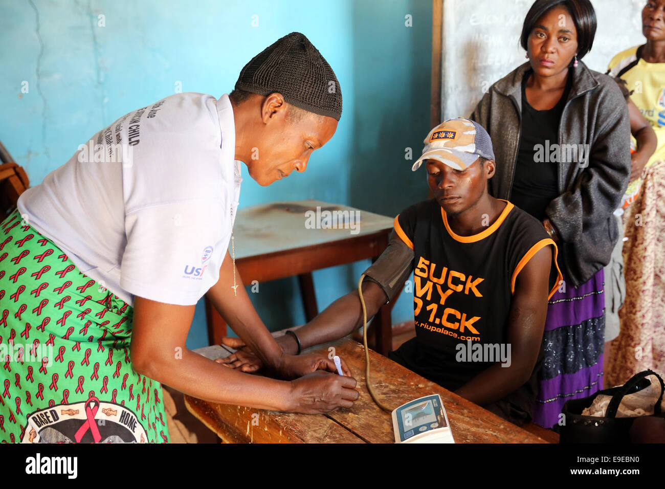 Man infected with HIV AIDS being checked by a health worker to receive ...