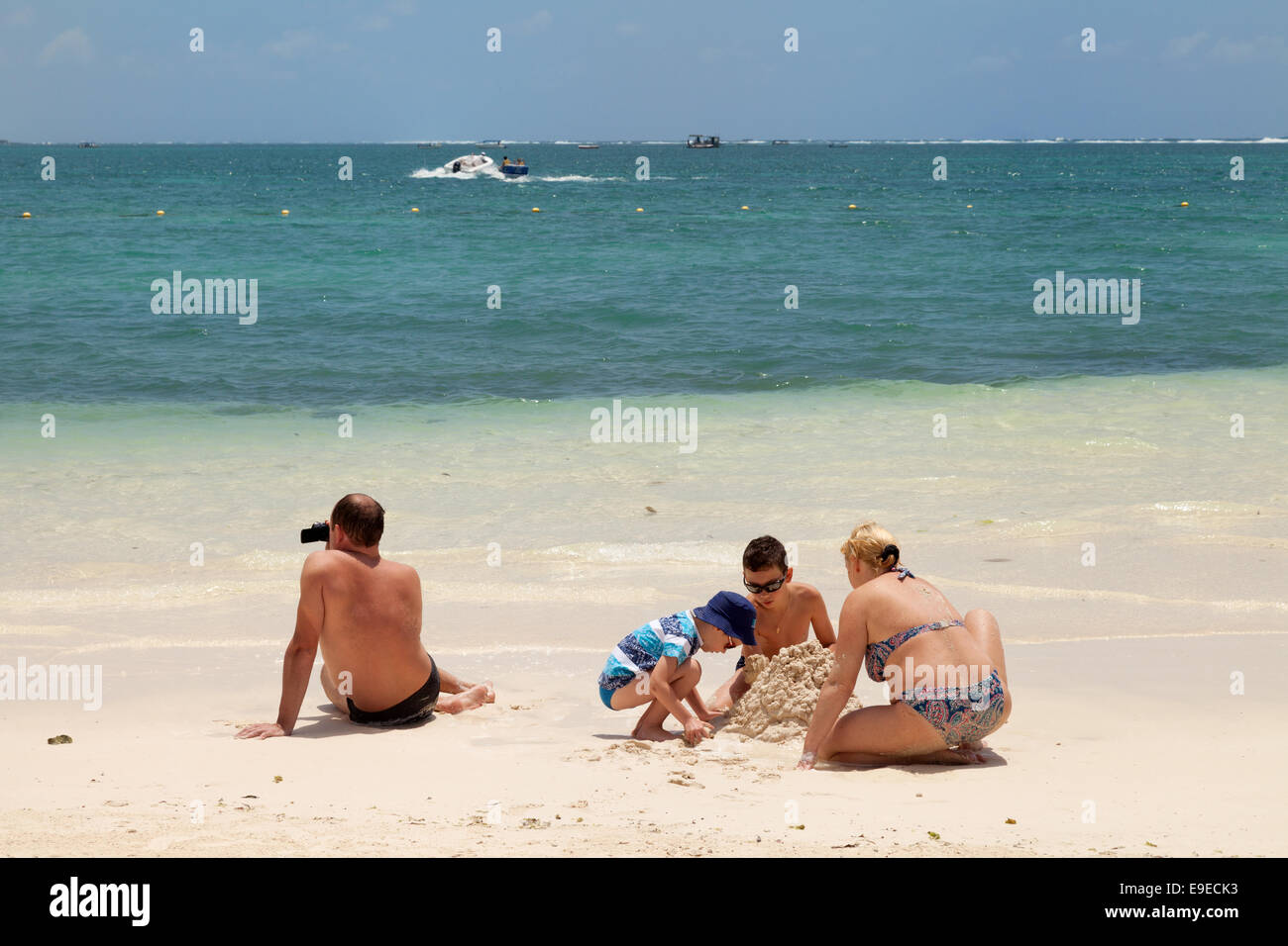 A caucasian family on holiday the beach, Belle Mare, Mauritius Stock Photo