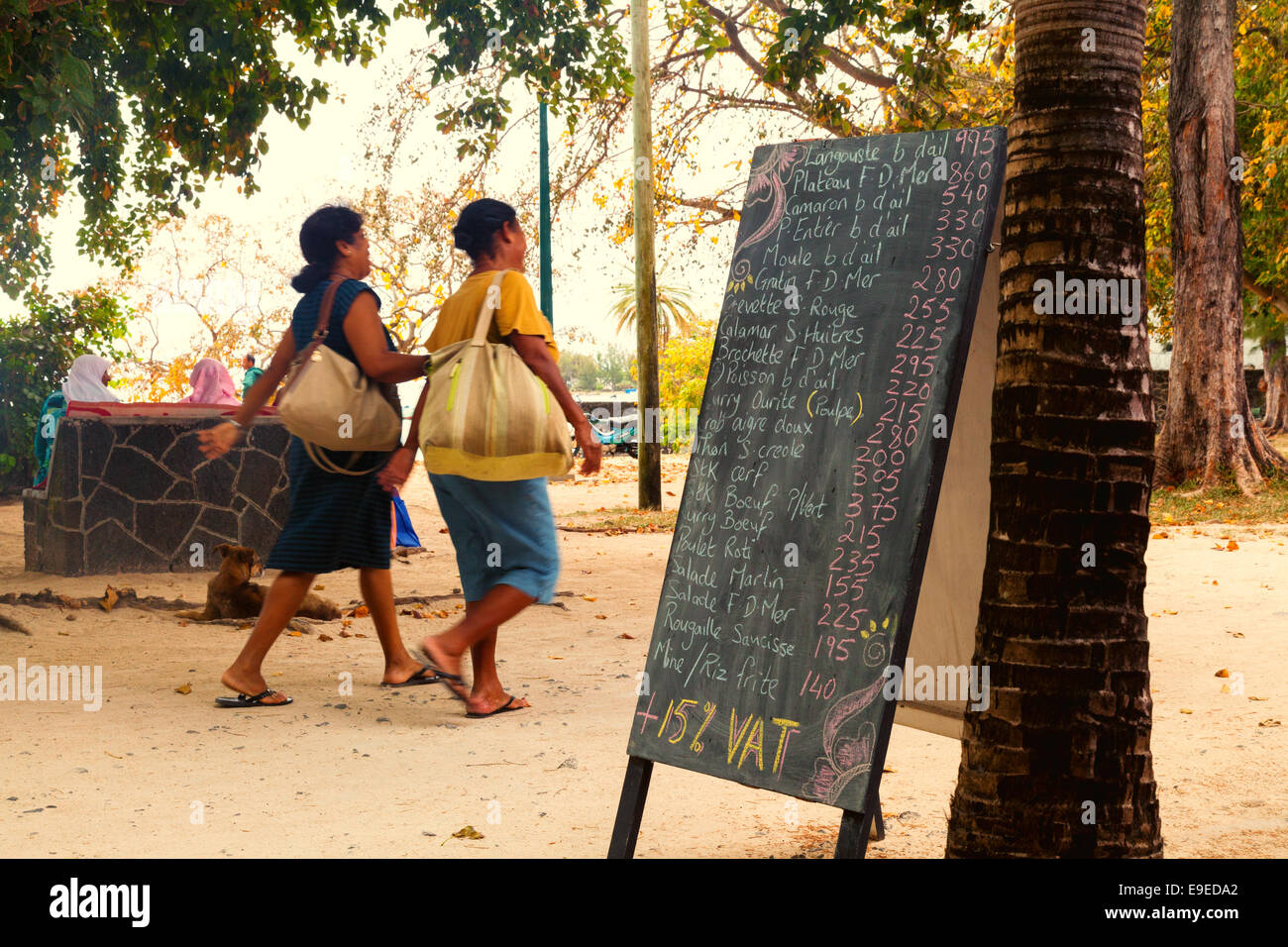 A restaurant menu and local people in the Grand Baie area, northern Mauritius Stock Photo