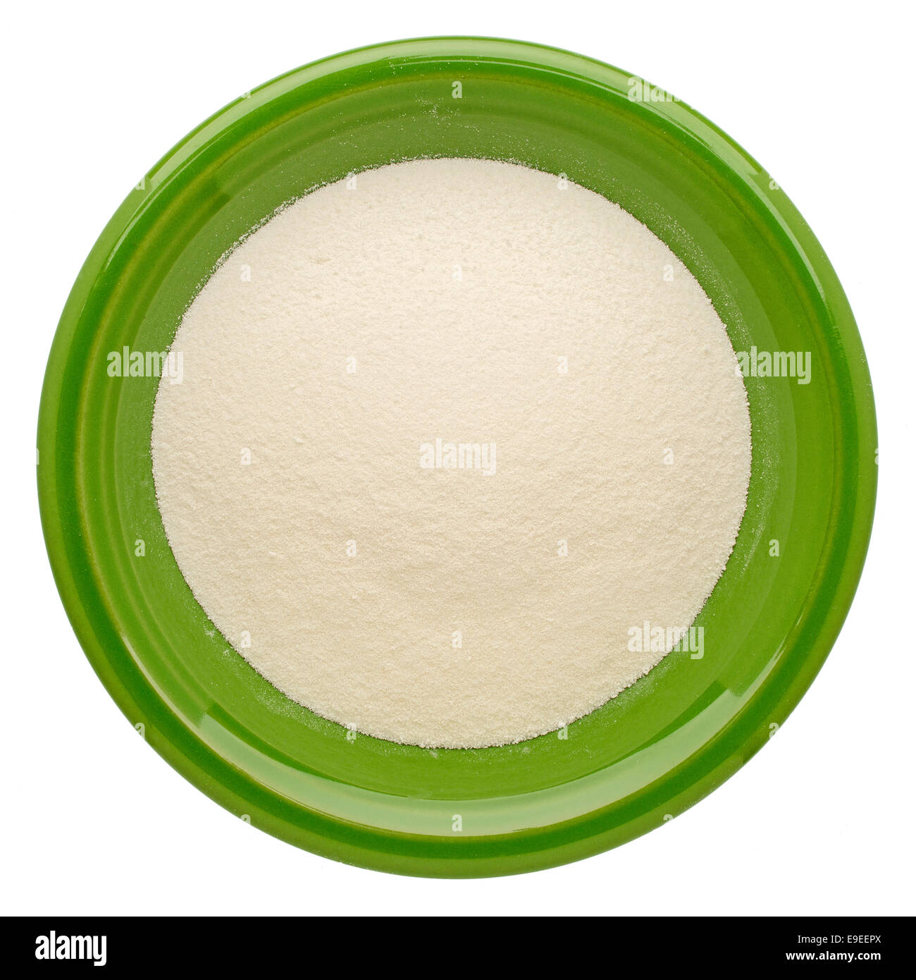 collagen protein powder on an isolated green ceramic bowl, top view Stock Photo