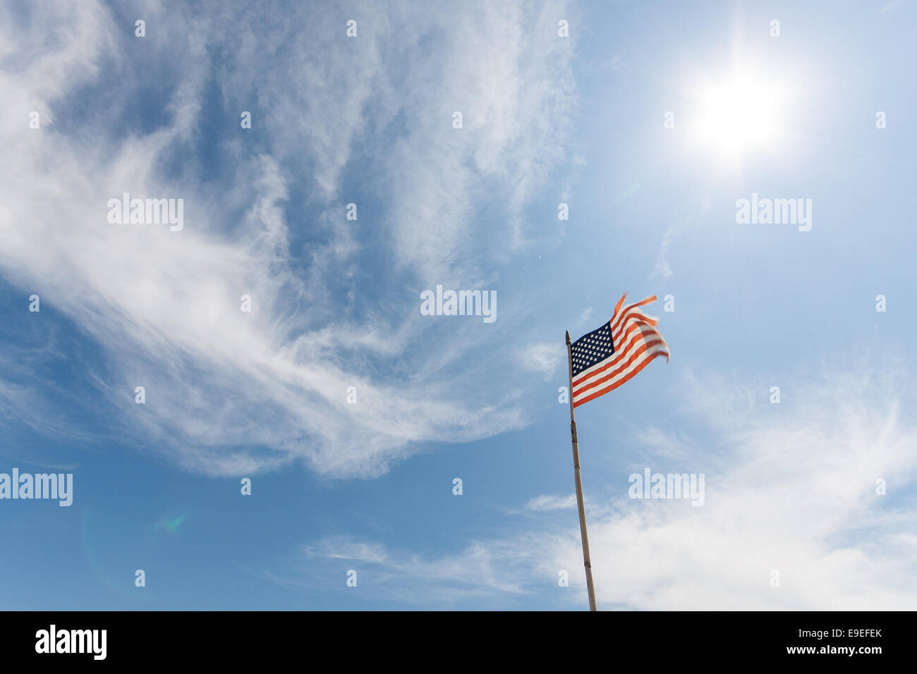 American flag against blue sky Stock Photo - Alamy