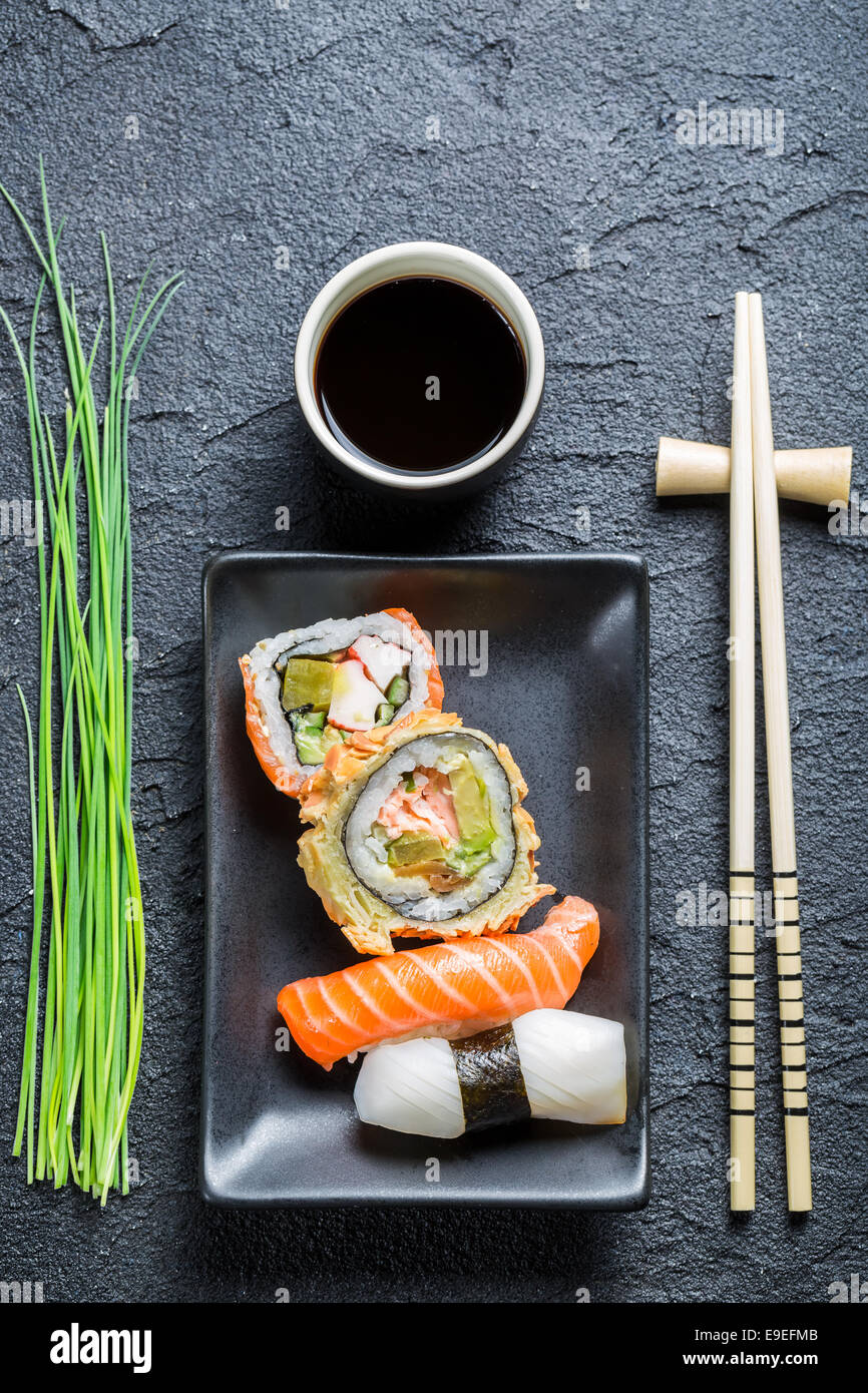 Fresh sushi, dark ceramic and chopstick Stock Photo