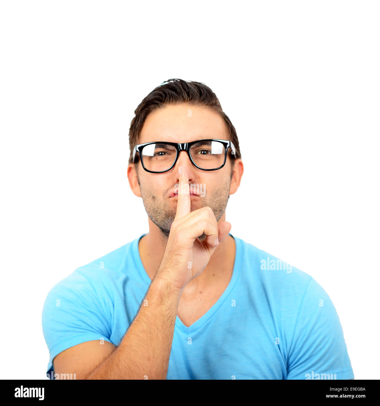 Portrait of man with gesture for silence against white background Stock Photo