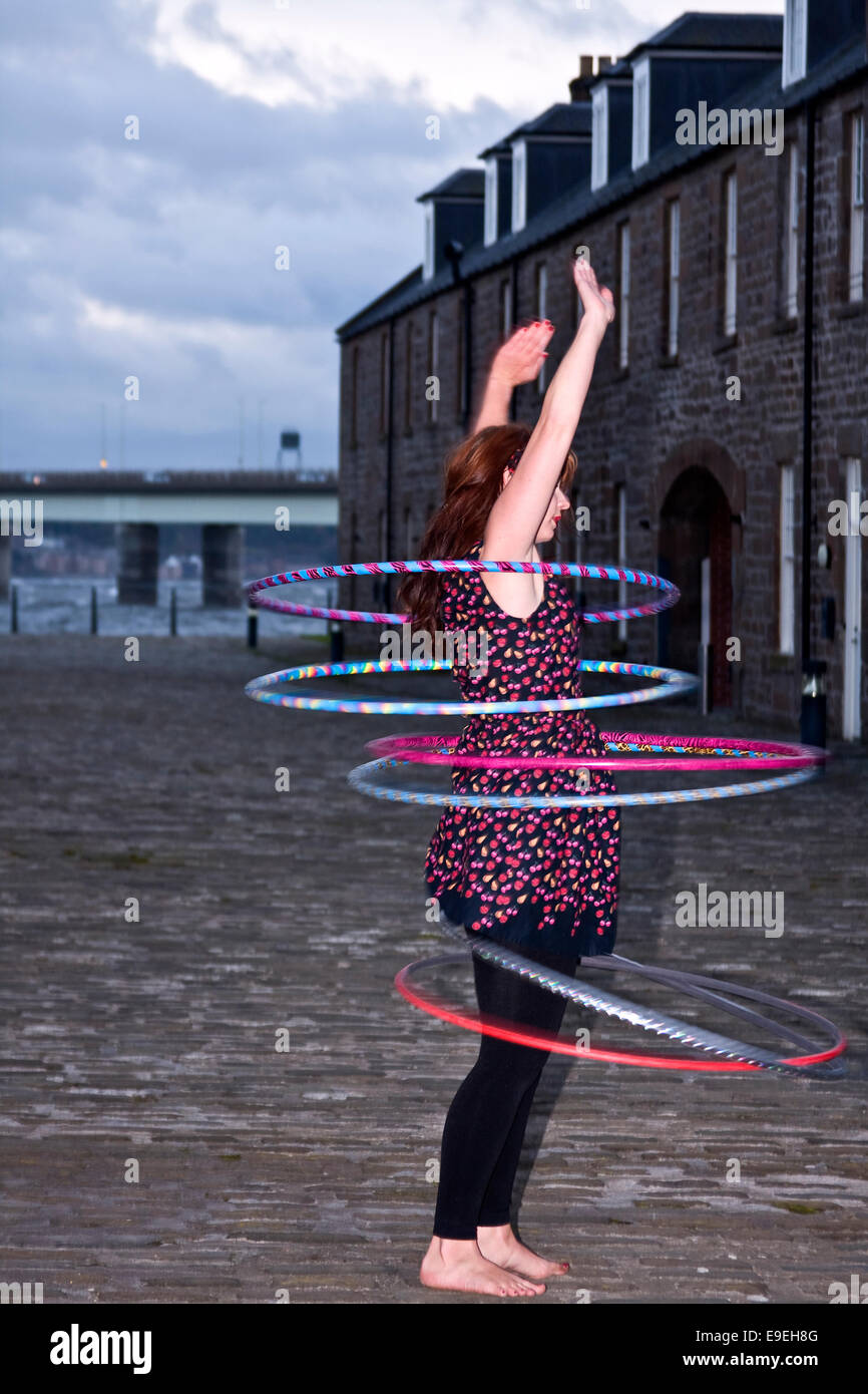Claire Nicoll Hula Hoop dancing on a cold and windy October afternoon at the Victoria Docks, City Quay in Dundee, UK Stock Photo