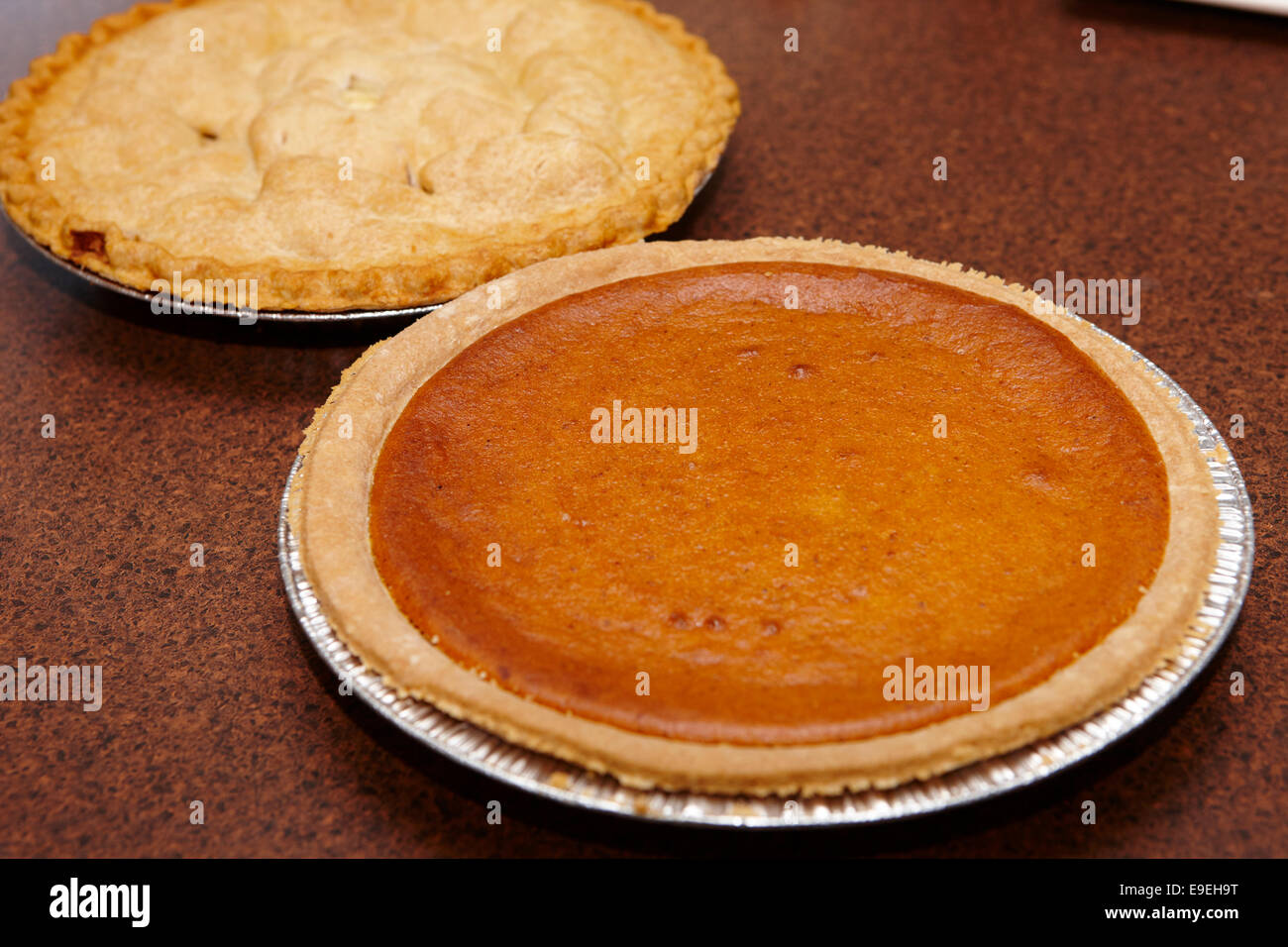 large round mass produced pumpkin and apple pies Stock Photo