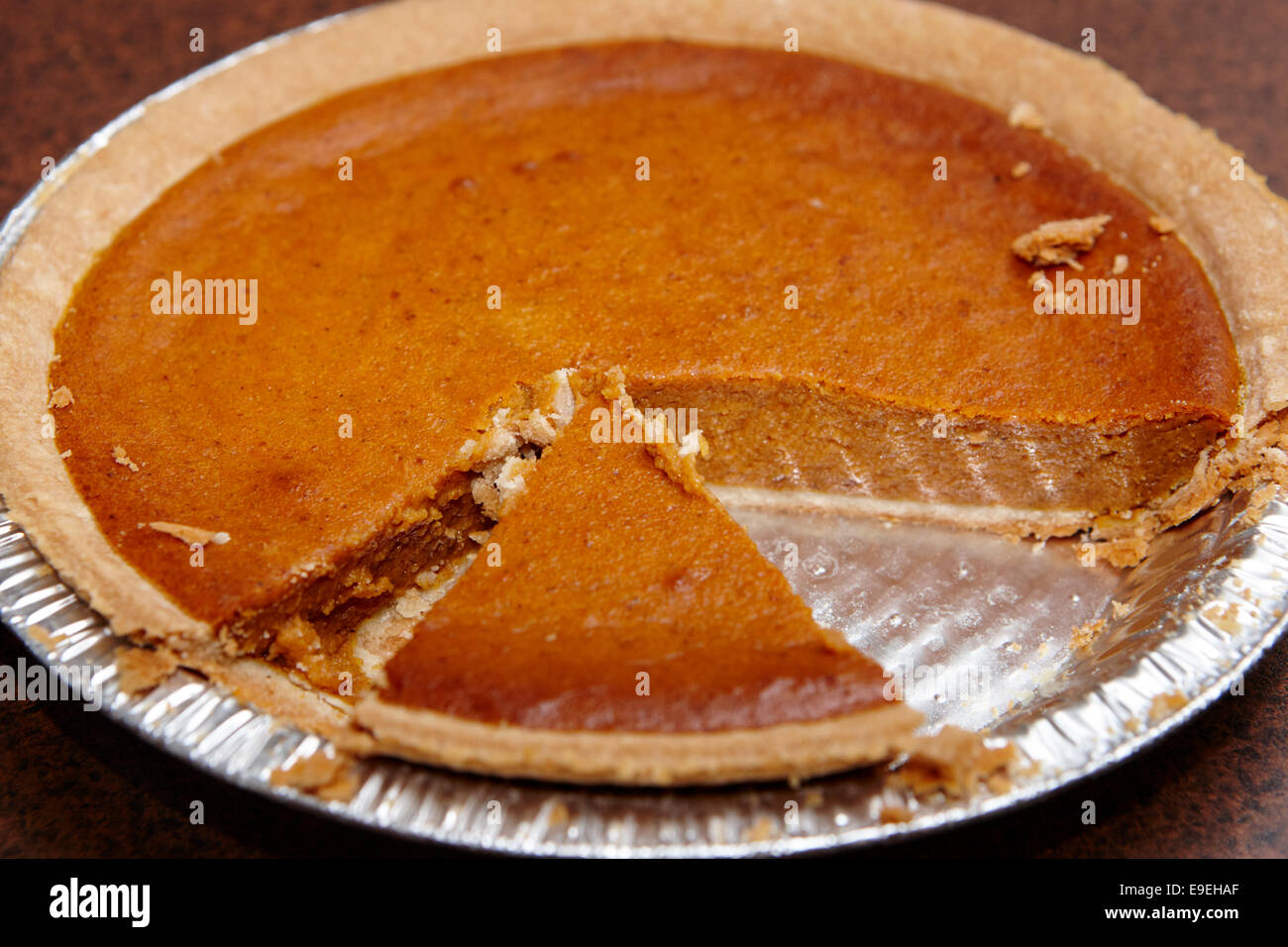 cross section of mass produced pumpkin pie Stock Photo