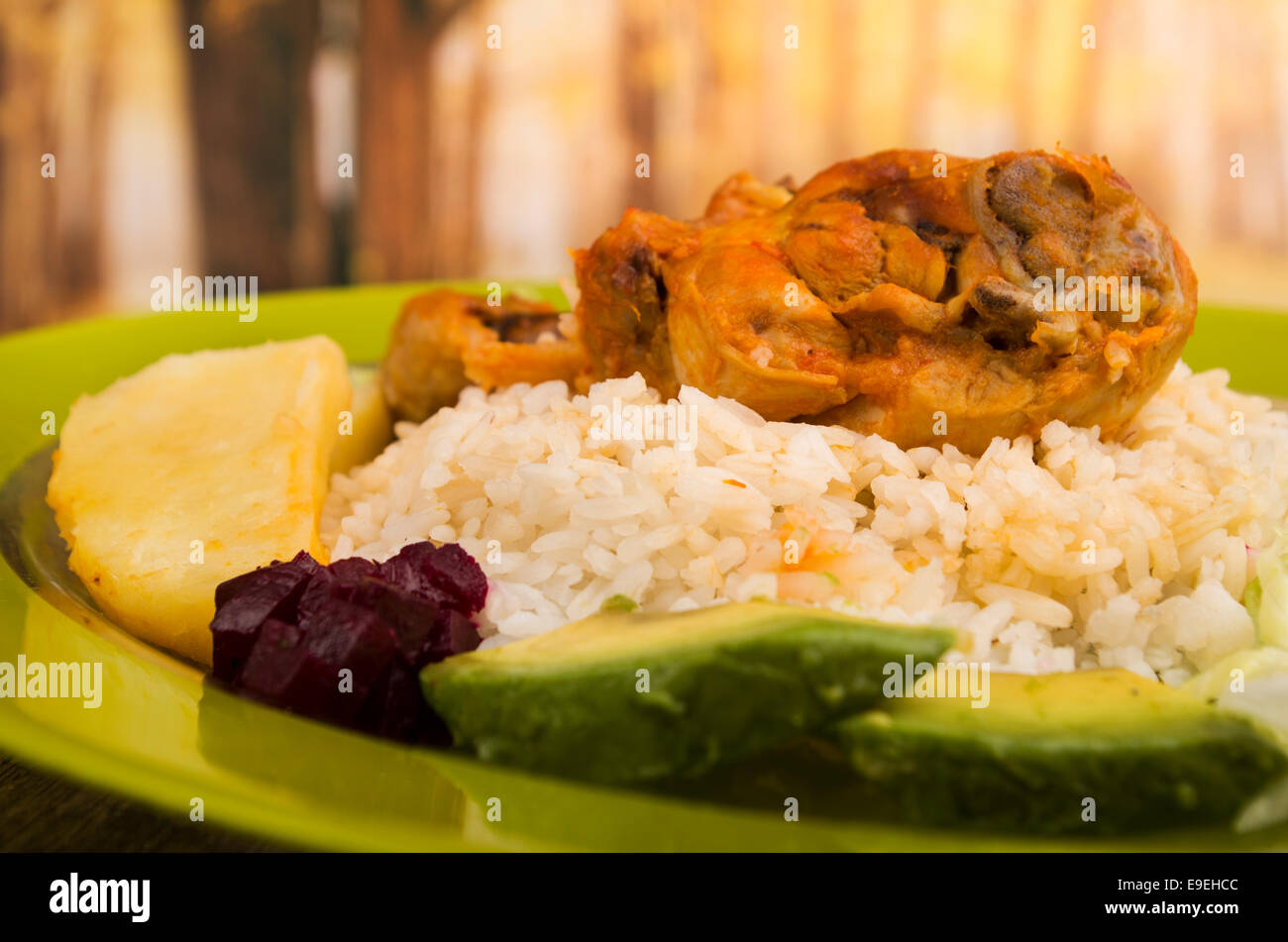 chicken served with white rice potato on a plate Stock Photo - Alamy