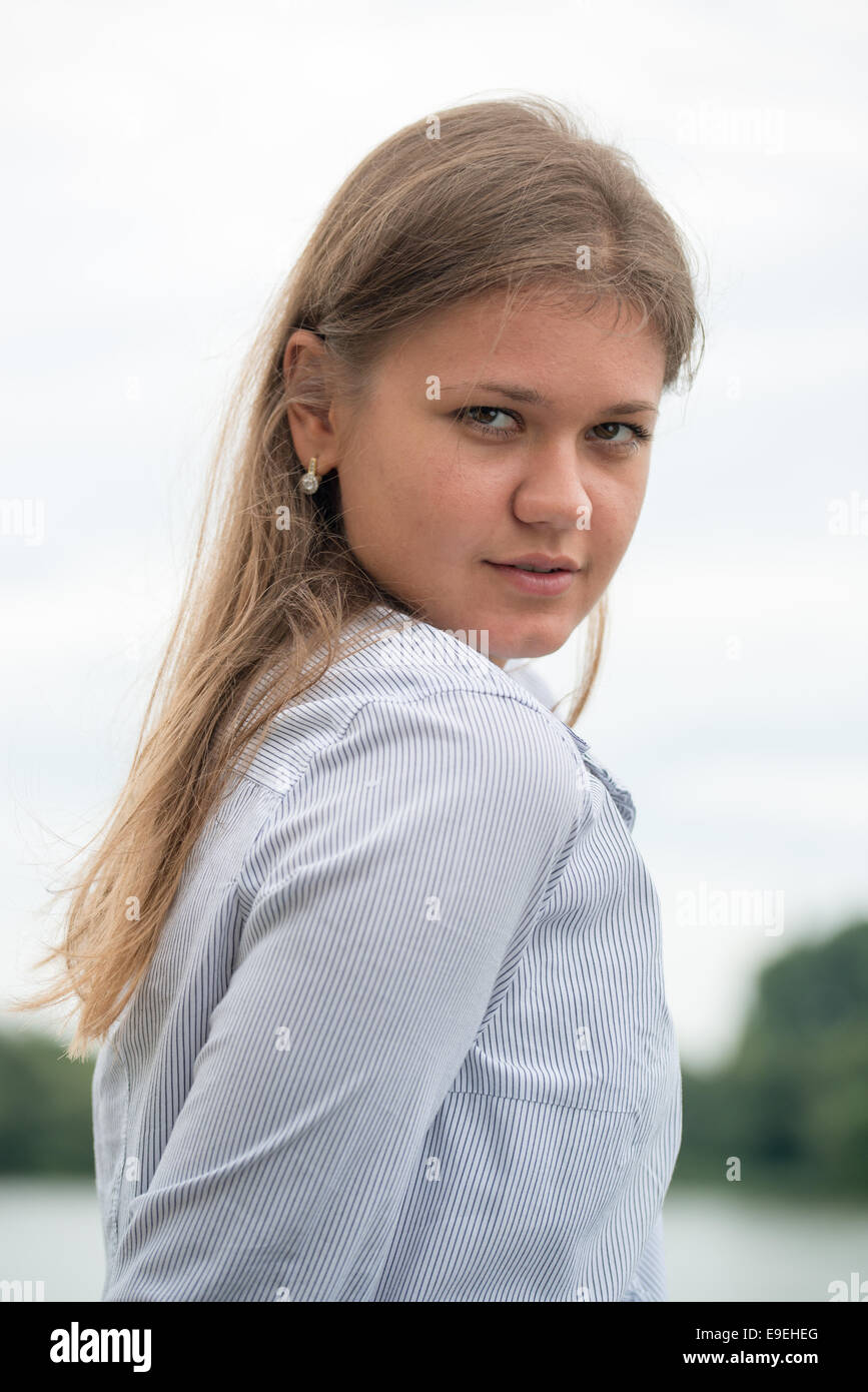 young business woman looking behind her shoulder Stock Photo