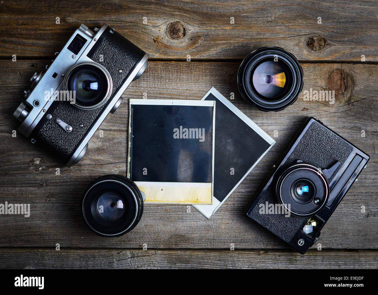 Vintage cameras with lenses and blank old photograph on wooden ...