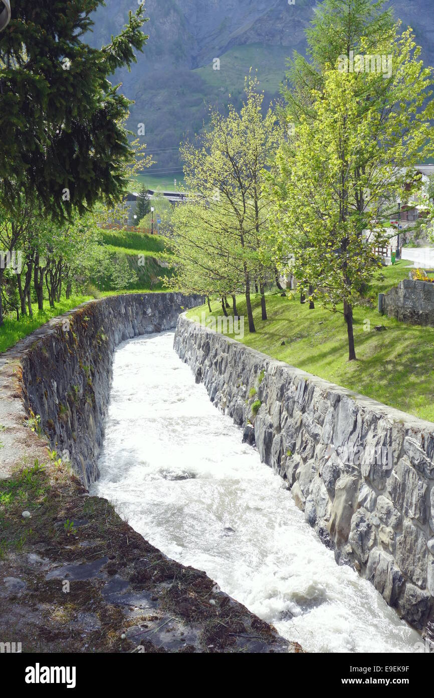 Swiss torrent flowing through the town of Leukerbad, Switzerland Stock Photo