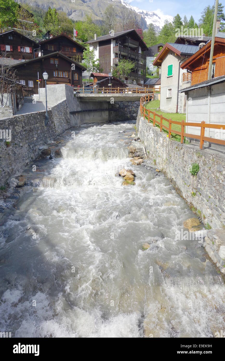 Swiss torrent flowing through the town of Leukerbad, Switzerland Stock Photo