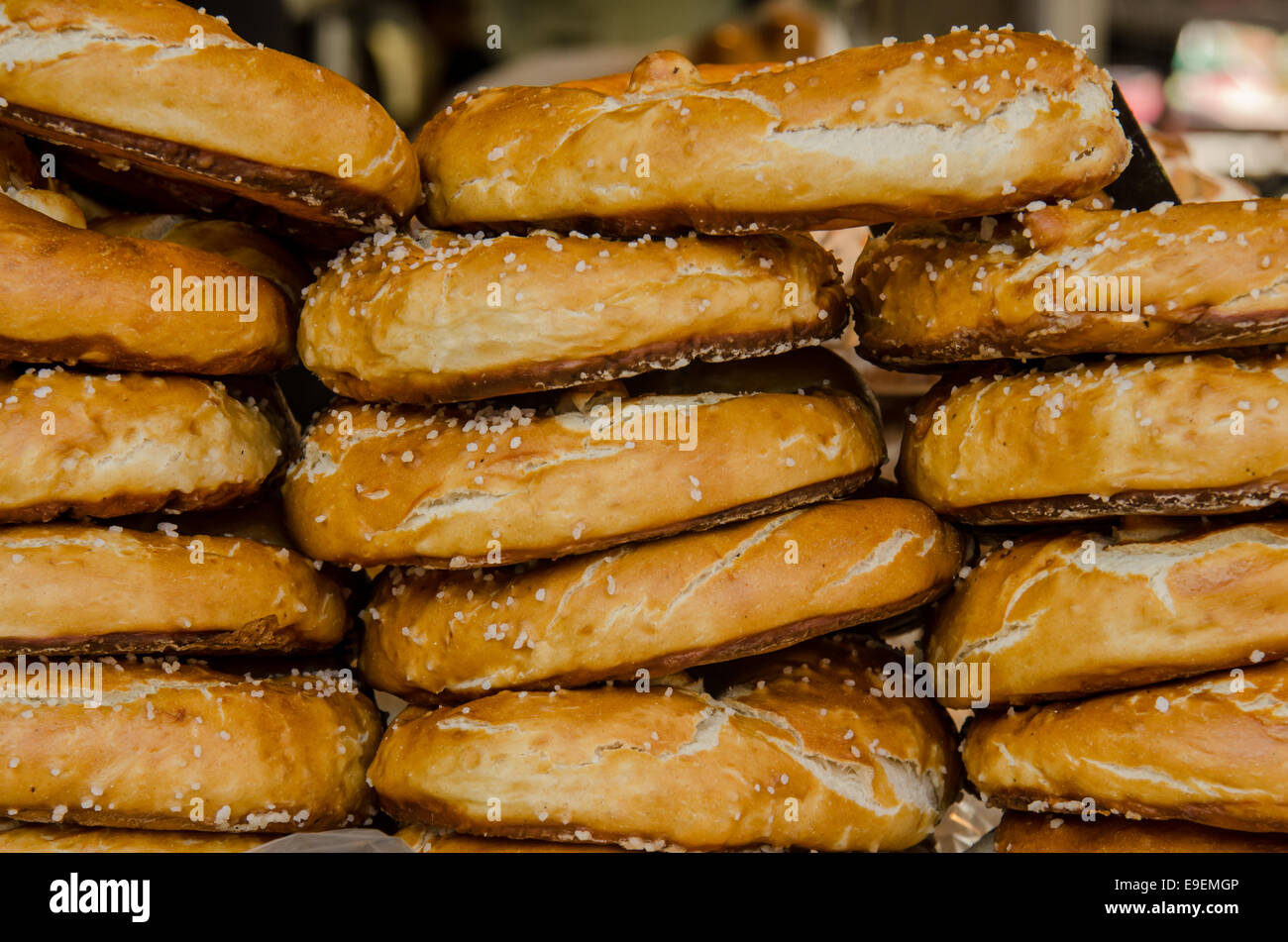 Fresh German Pretzels are stacked and ready to sell at a farmers market in Groningen, The Netherlands Stock Photo
