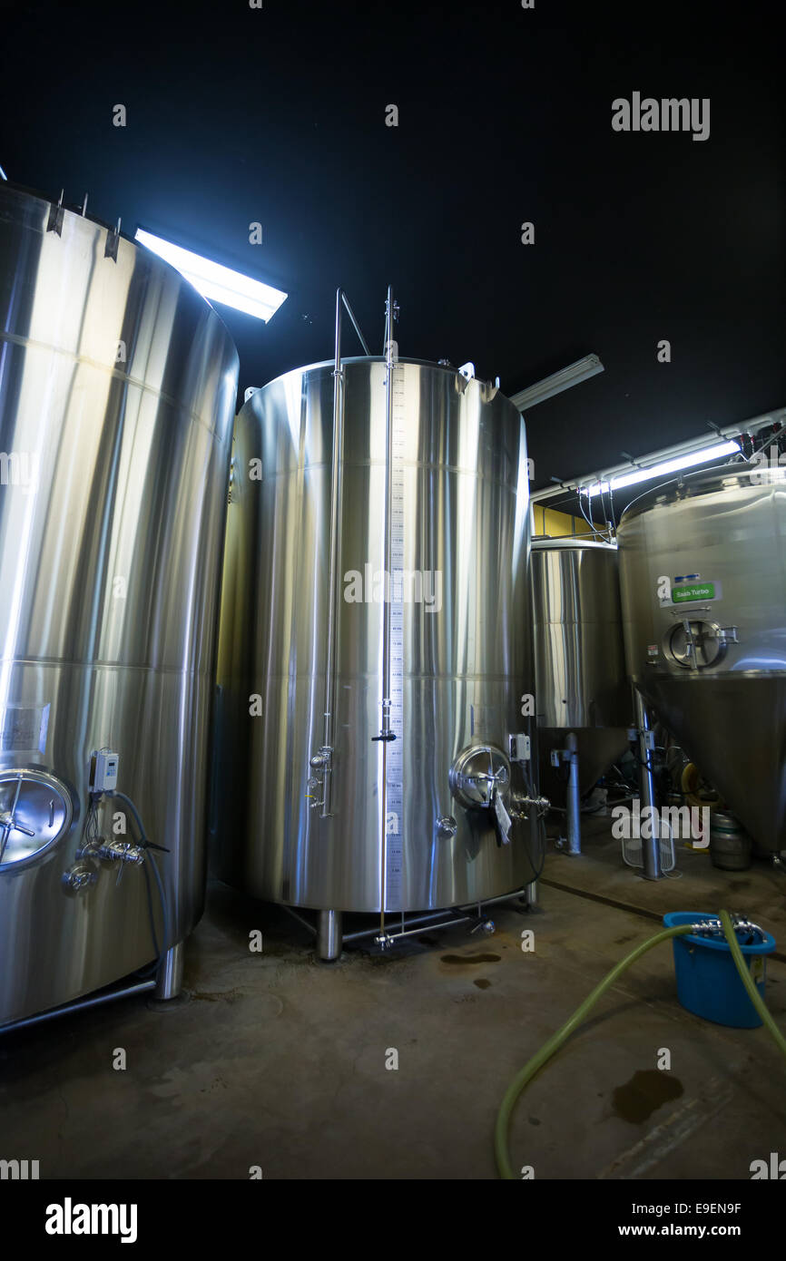 Eugene, OR, USA - July 17, 2014: Stainless steel fermenters in the brewing room at Oakshire Brewery, a small craft beer maker in Stock Photo