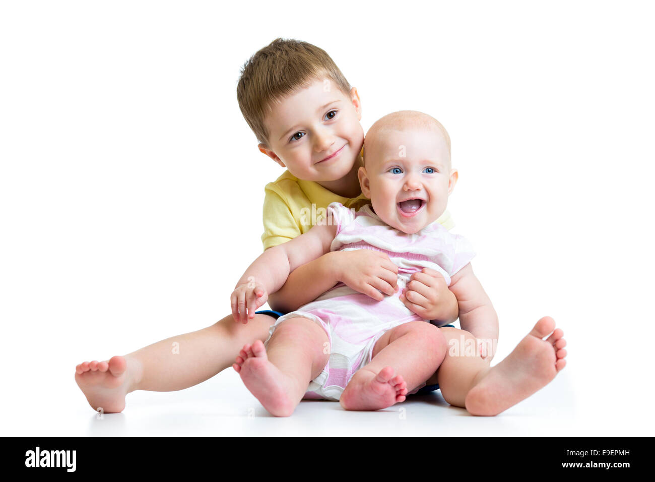 Loving brother and little sister hugging isolated Stock Photo
