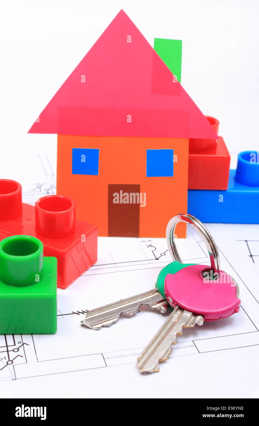 House of colored paper, home keys and plastic building blocks on construction drawing of house, concept of building home Stock Photo