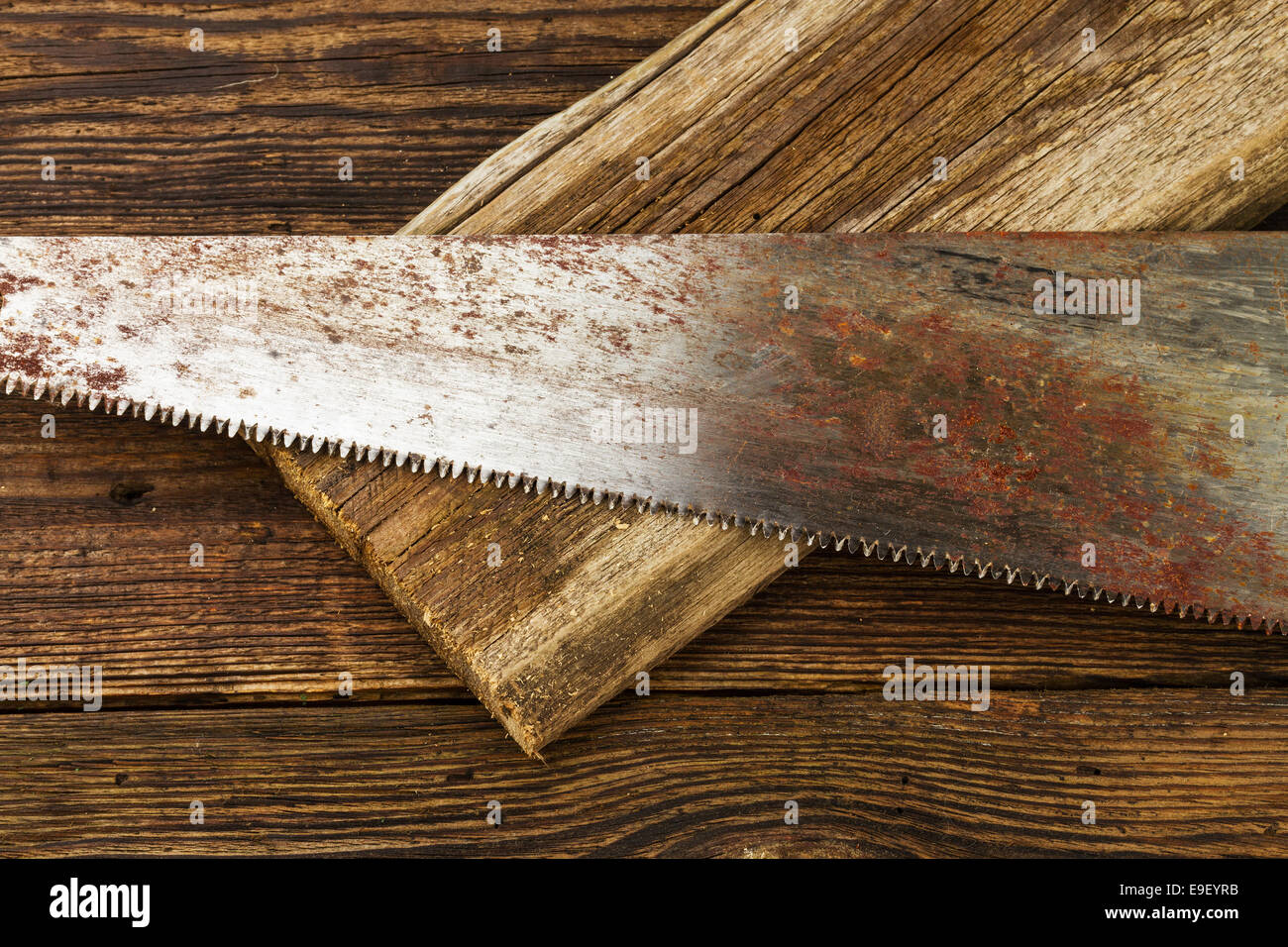 hacksaw and board on wooden background Stock Photo