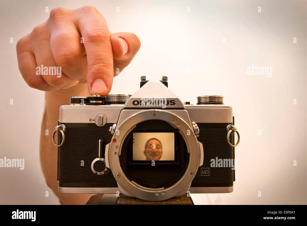 olympus film camera with the lens off showing a face in the camera