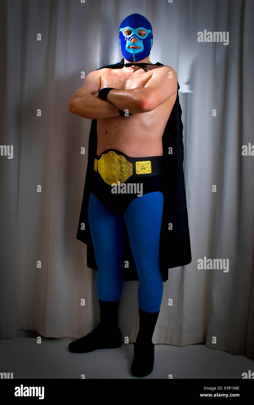 man in a mexican wrestlers lucha libre outfit with mask, cape, wrestling  belt and leggins Stock Photo - Alamy