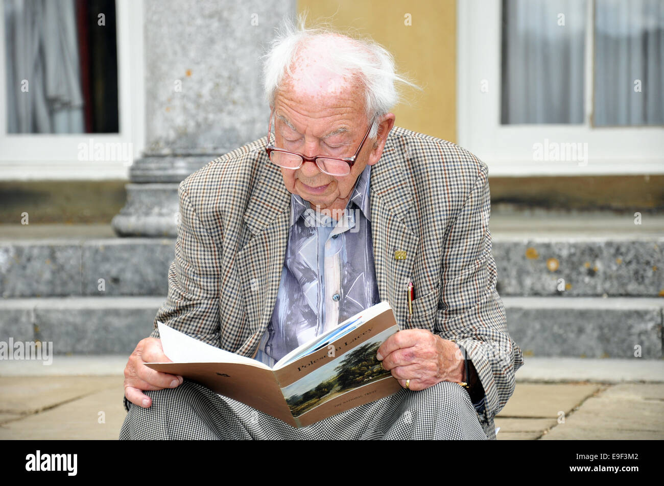 Bespectacled Well Dressed Old Man With White Hair Wearing A Stock