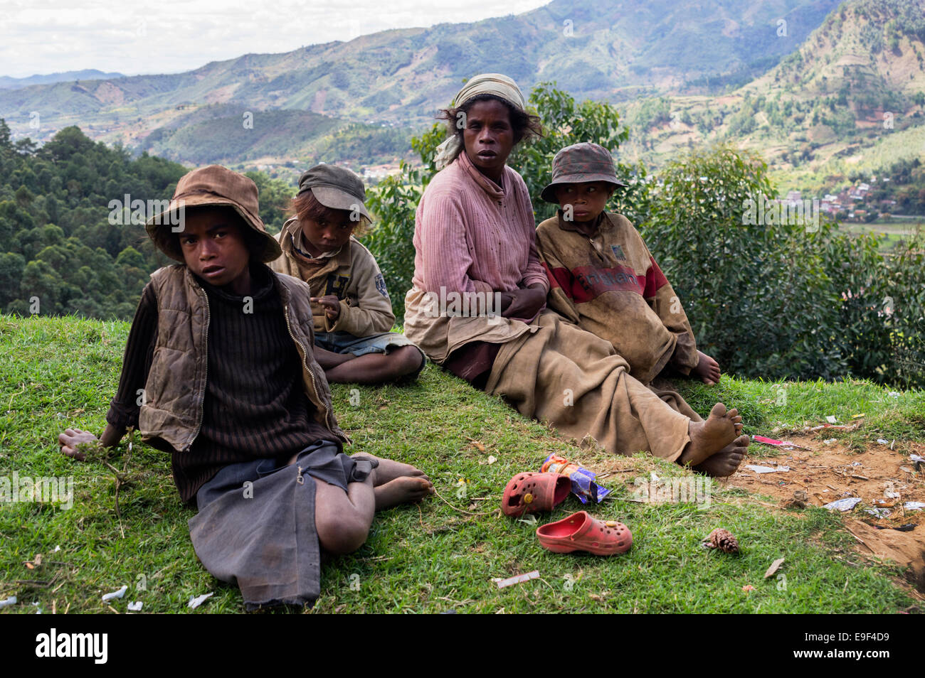 A madagascan family sitting by the side of a road Stock Photo