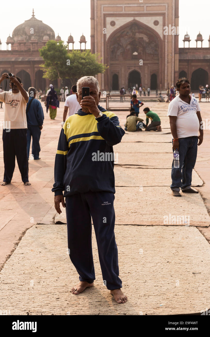 Man taking pictures with his mobile phone. Jama Masjid, Fatehpur Sikri, Uttar Pradesh, India Stock Photo