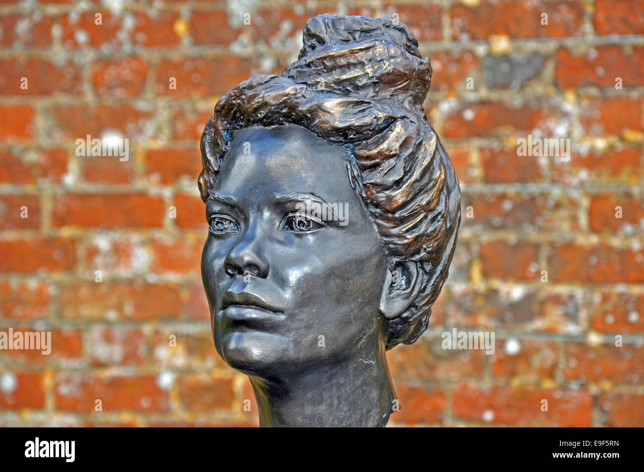 Bronze woman head sculpture/bust, on display outdoors as a garden