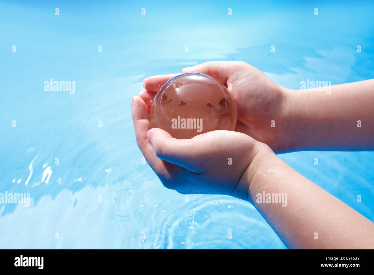 Man bending over, holding water in cupped hands, cropped view - Stock Photo  - Dissolve