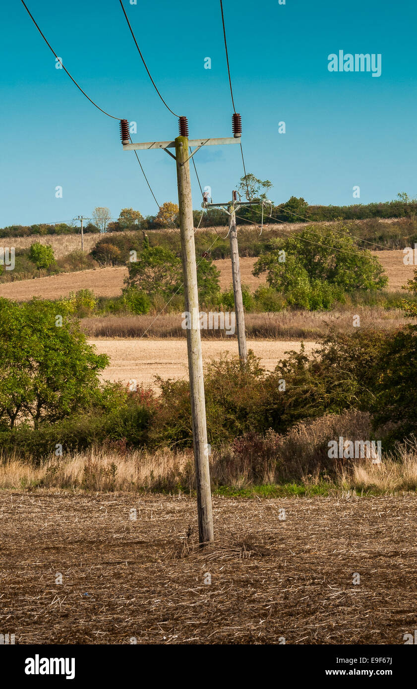 Electrical cables running across farm land in Lincolnshire, England Stock Photo