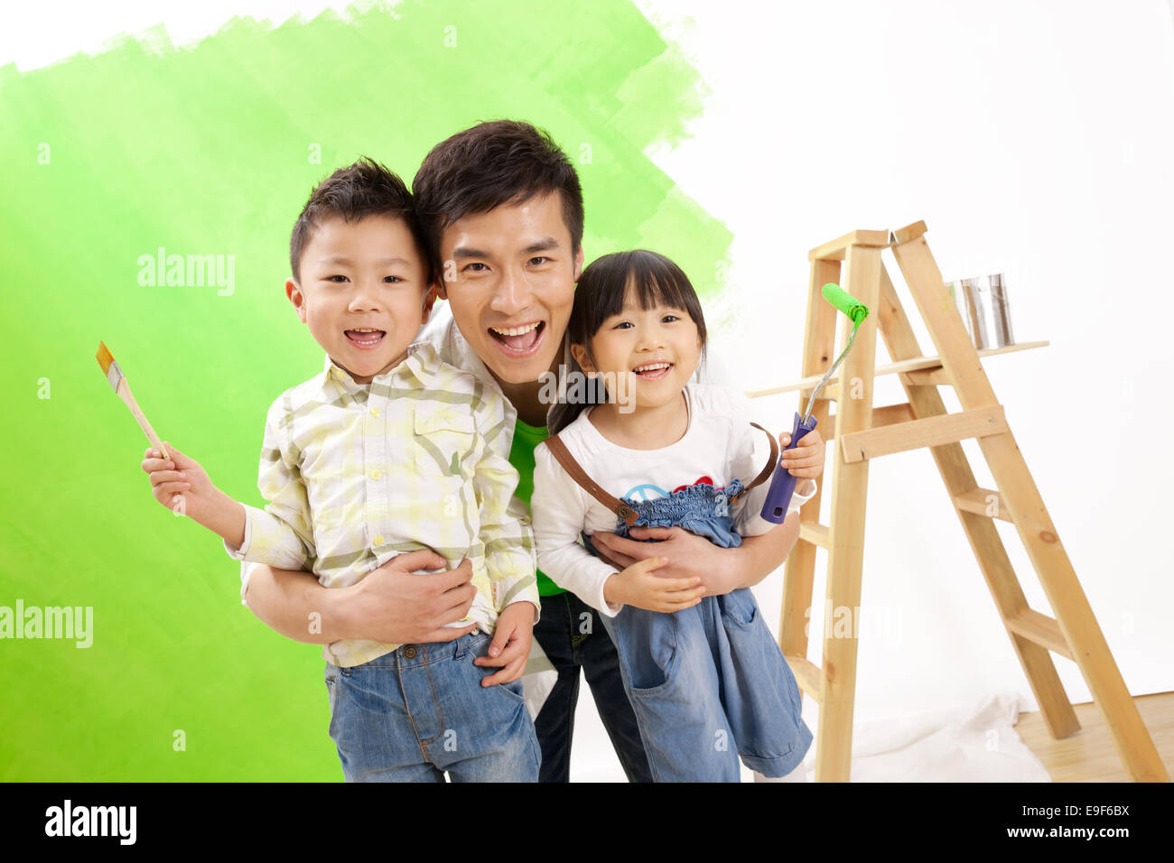 Happy family decorating the house Stock Photo