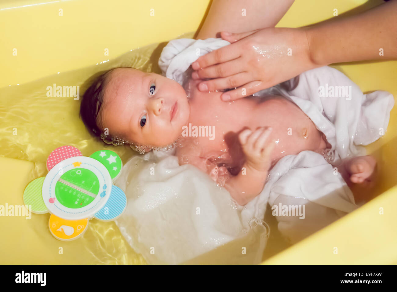 New born baby is receiving a bath from his mommy Stock Photo - Alamy