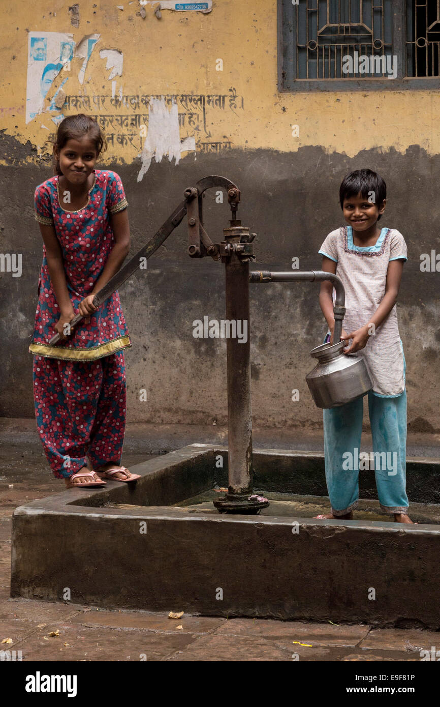 Two girls taking water. Muslim area, Varanasi, Uttar Pradesh, India Stock Photo