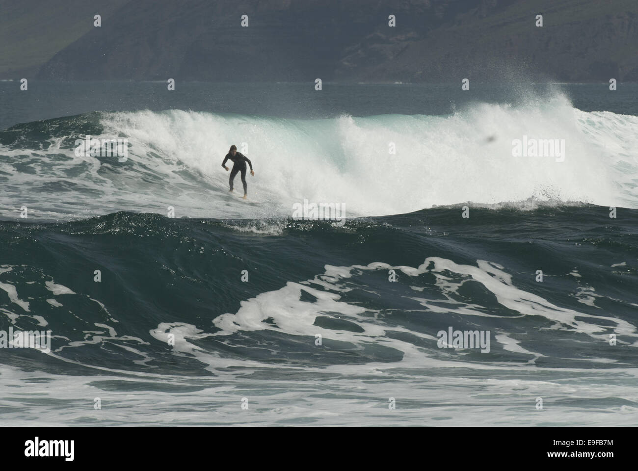 Surfer on the Beach of Famara, Lanzarote Stock Photo