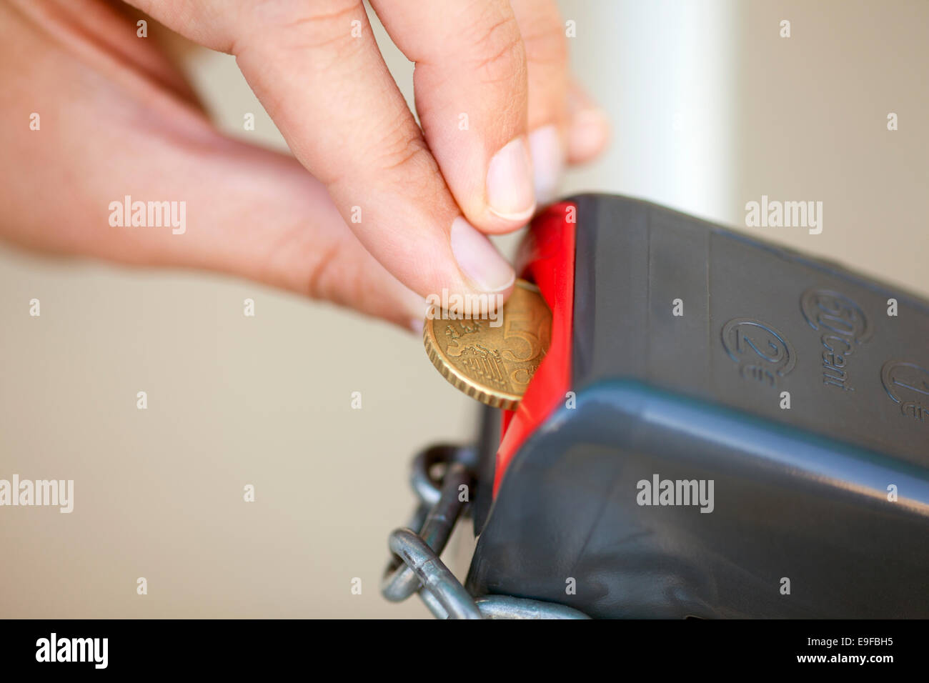 Woman's hand putting 50 euro cent into lock Stock Photo