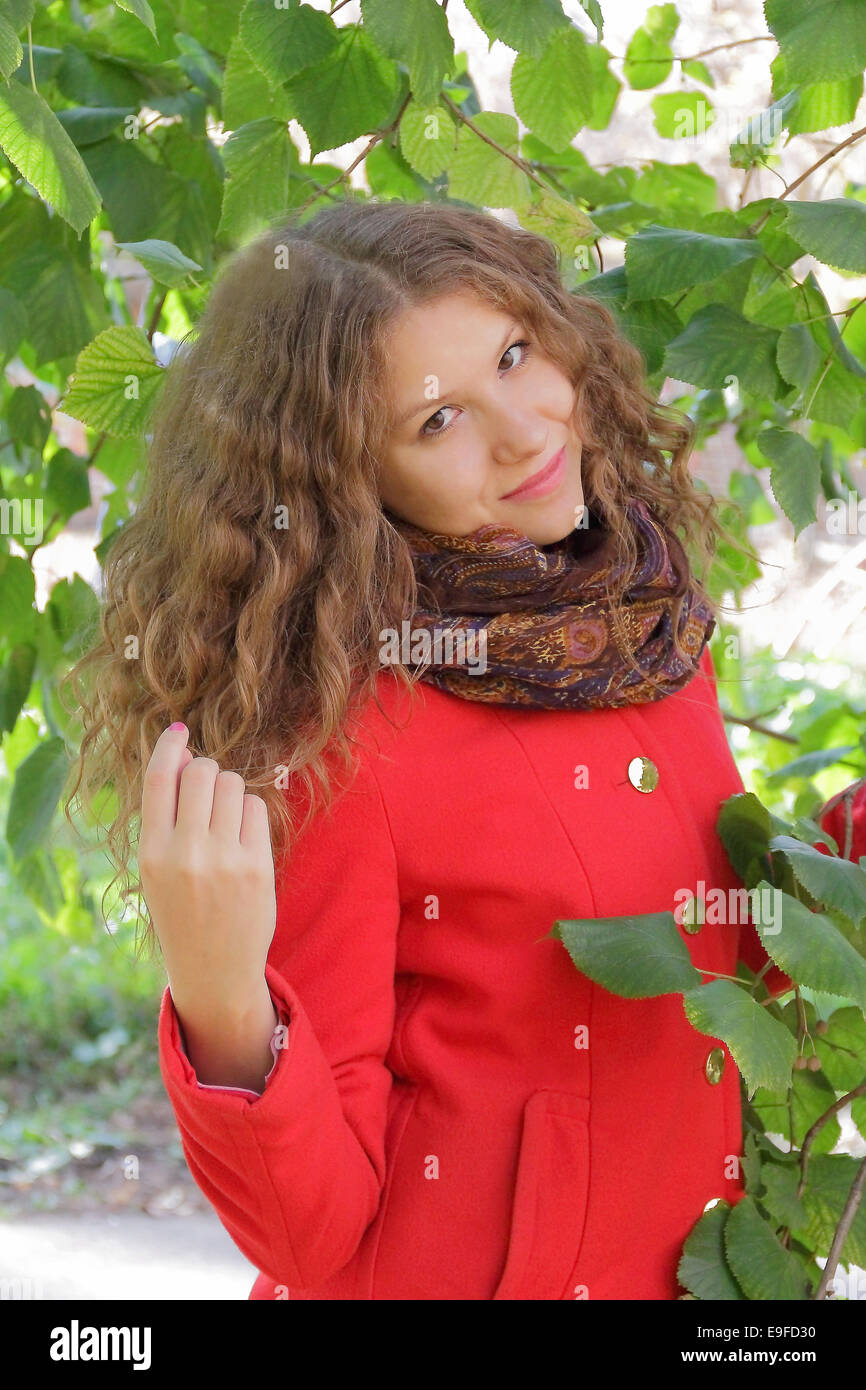 Beautiful young woman in red coat Stock Photo