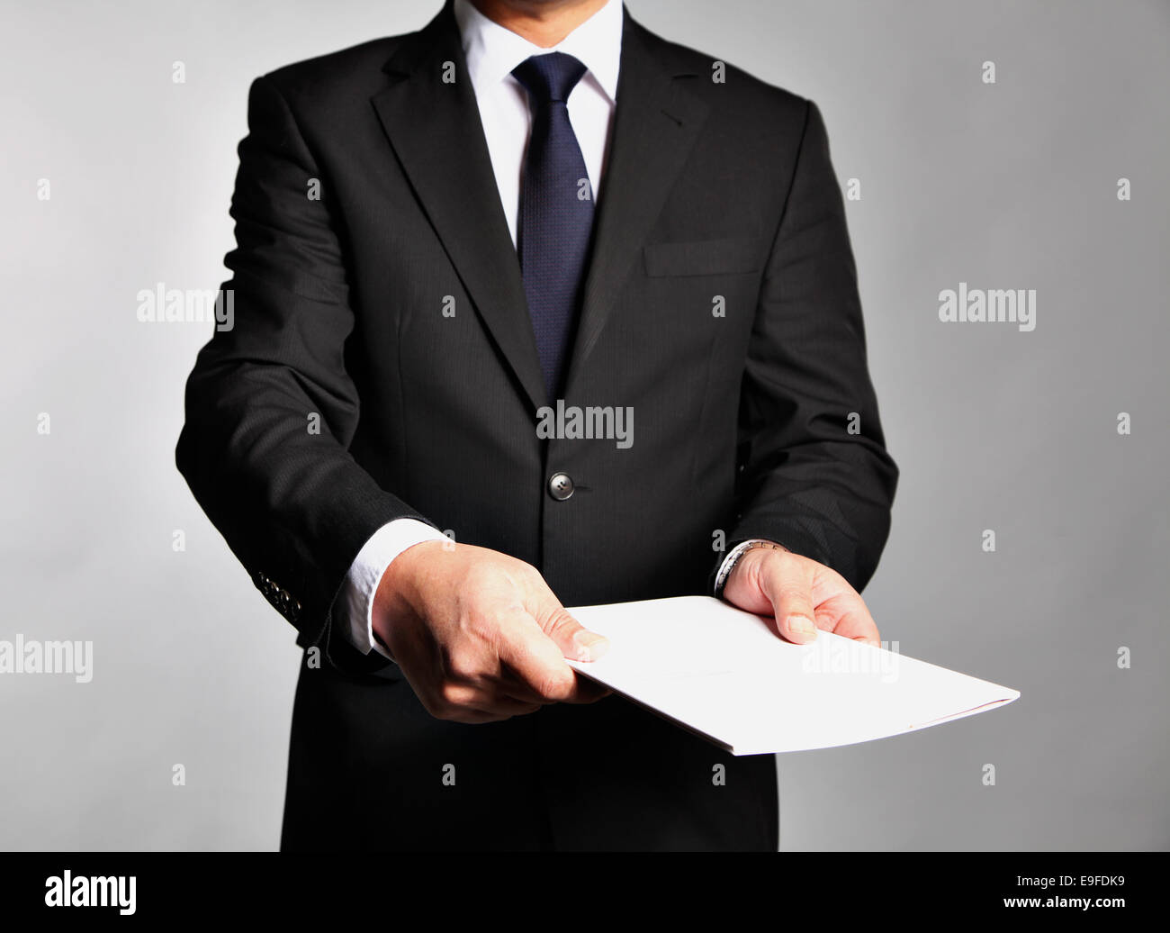 Businessman holds a booklet Stock Photo