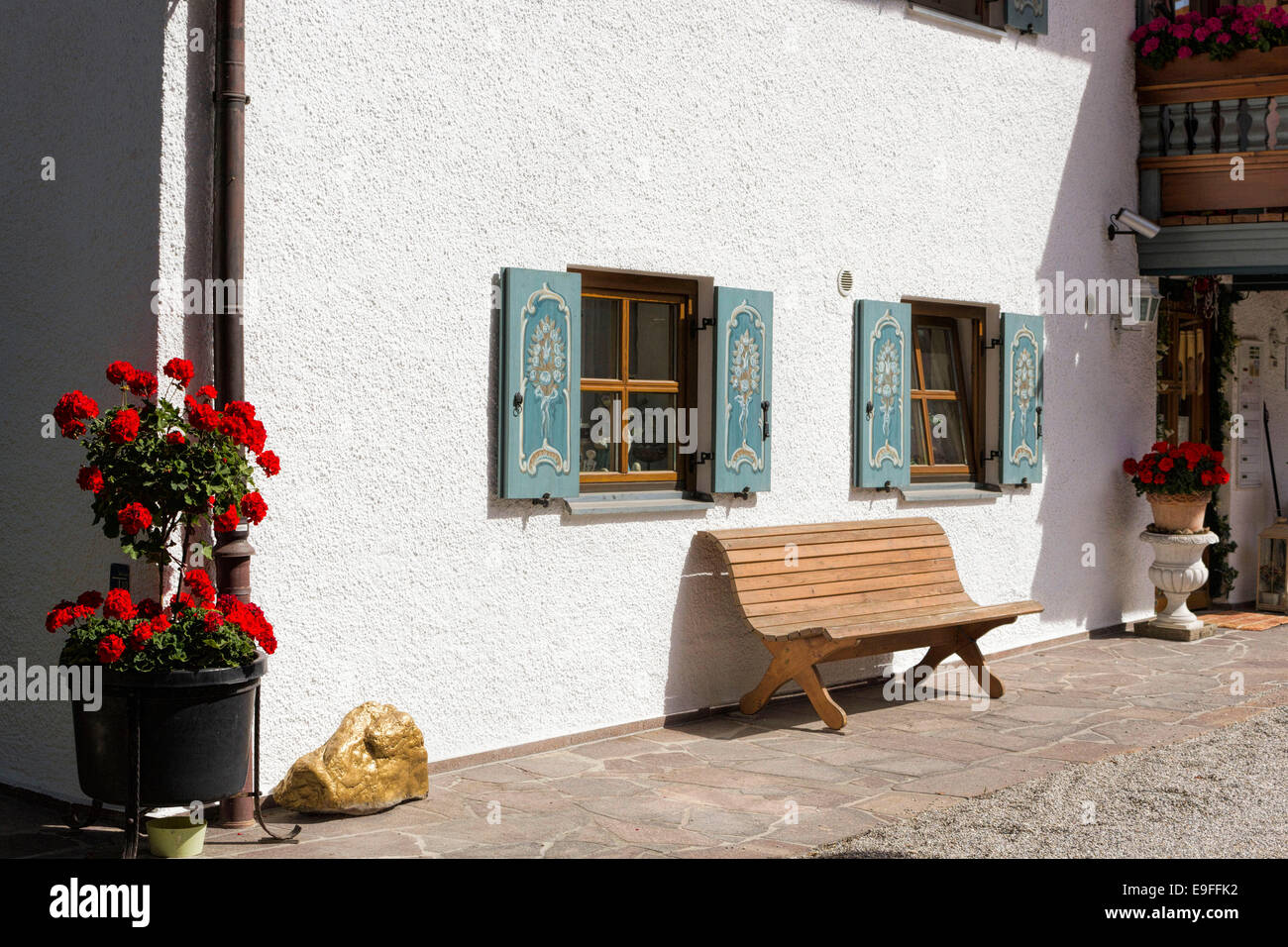 Bavarian architecture, windows, red Geranium flowers and bench seat, Bad Aibling, Upper Bavaria, Germany, Europe. Stock Photo