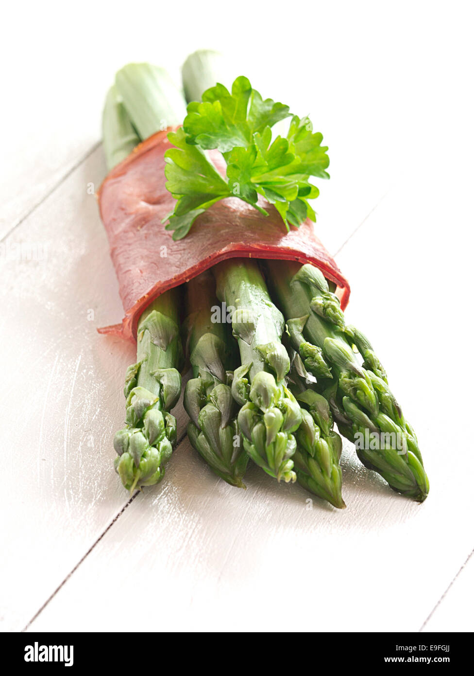 Green asparagus cooked with ham Stock Photo