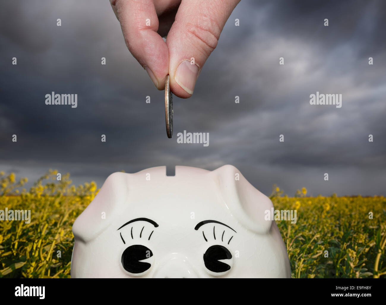 Saving money in piggy bank with fingers Stock Photo
