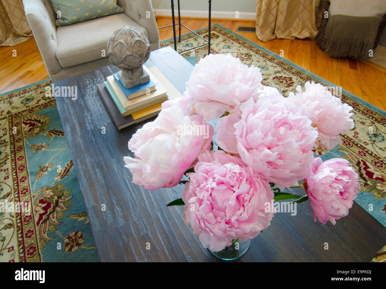 Vase of Peonies A vase of freshcut peonies with a wood bowl Stock