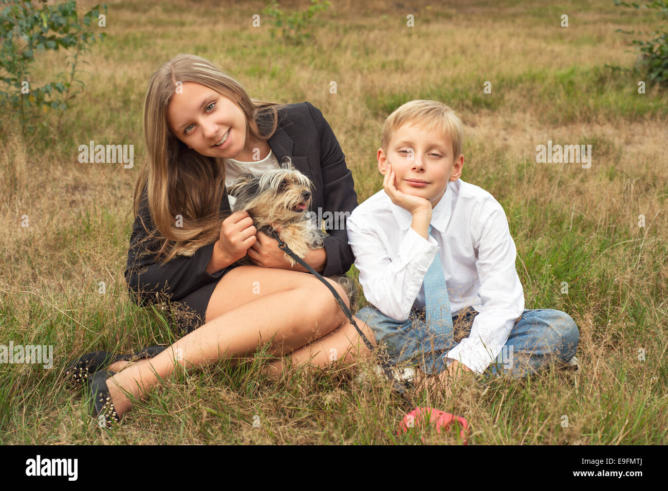 Children sit in the park with a dog Stock Photo - Alamy