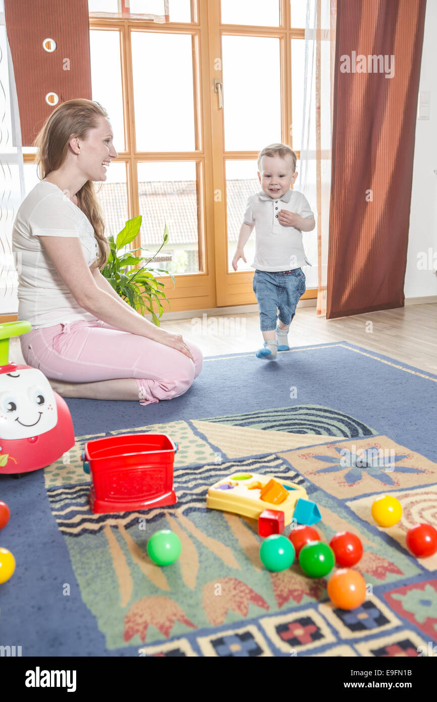 young mother with a toddler by playing at home Stock Photo