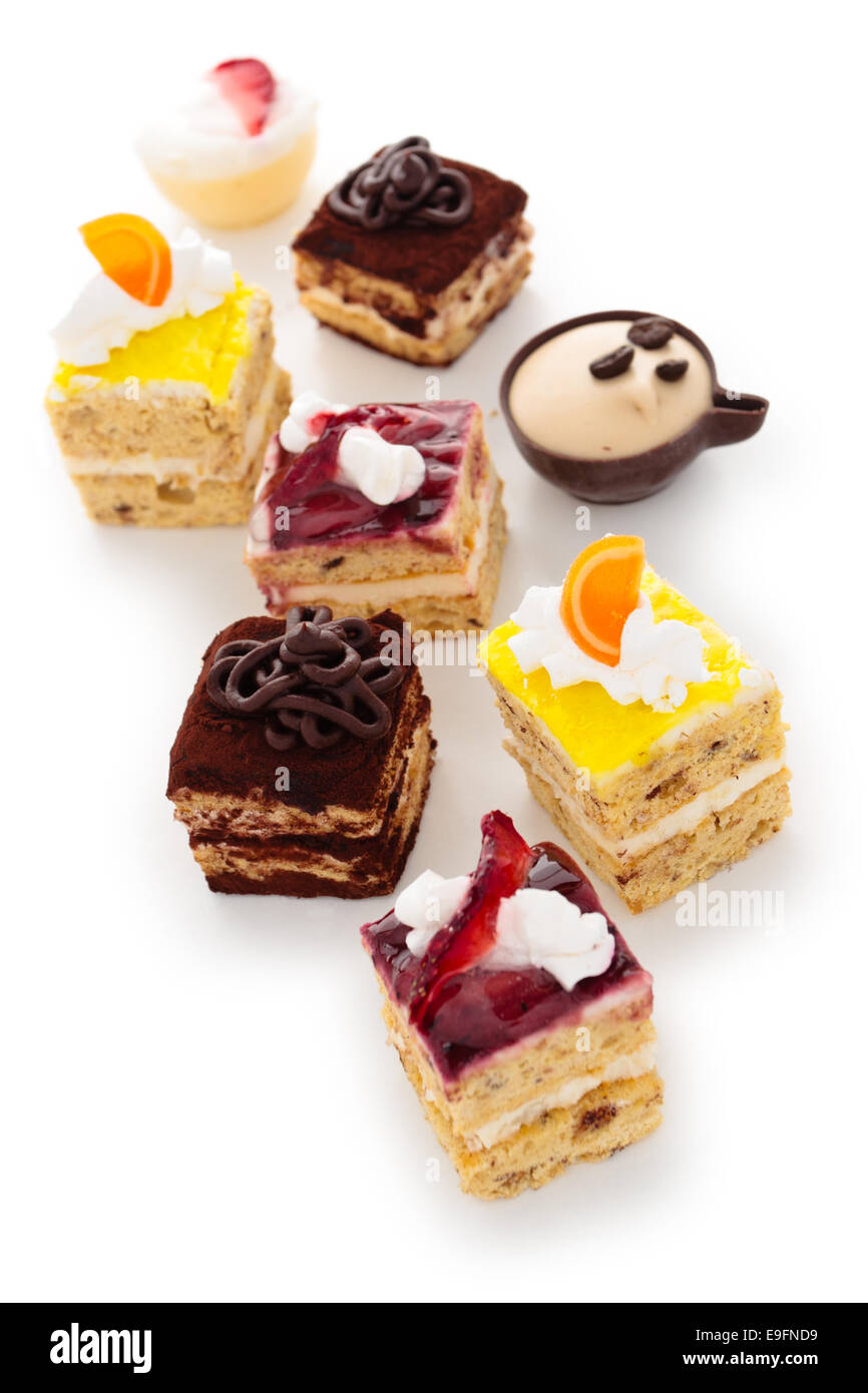 Collection of different small cakes on plate. Stock Photo
