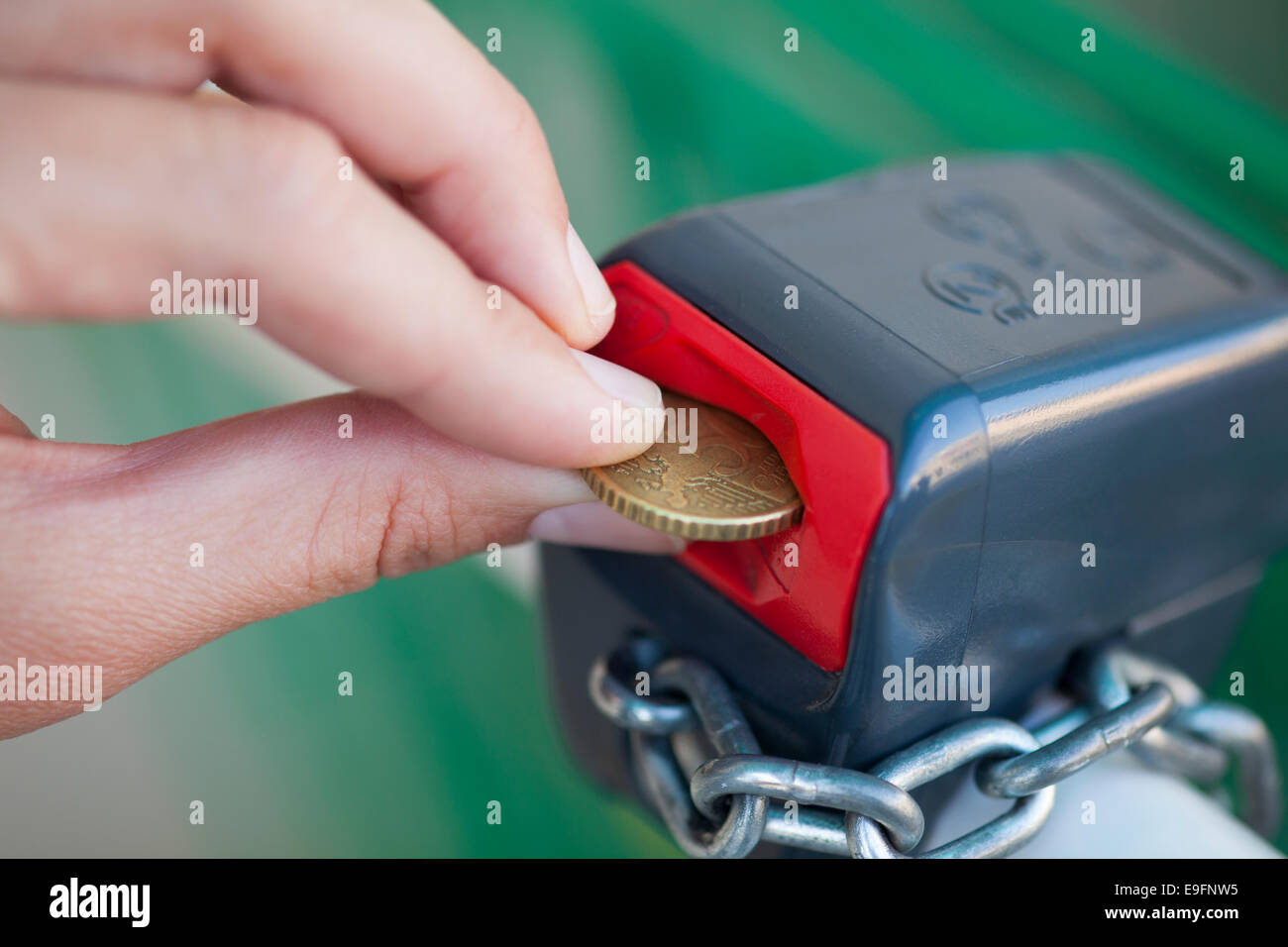 Woman's hand putting 50 euro cent into lock Stock Photo