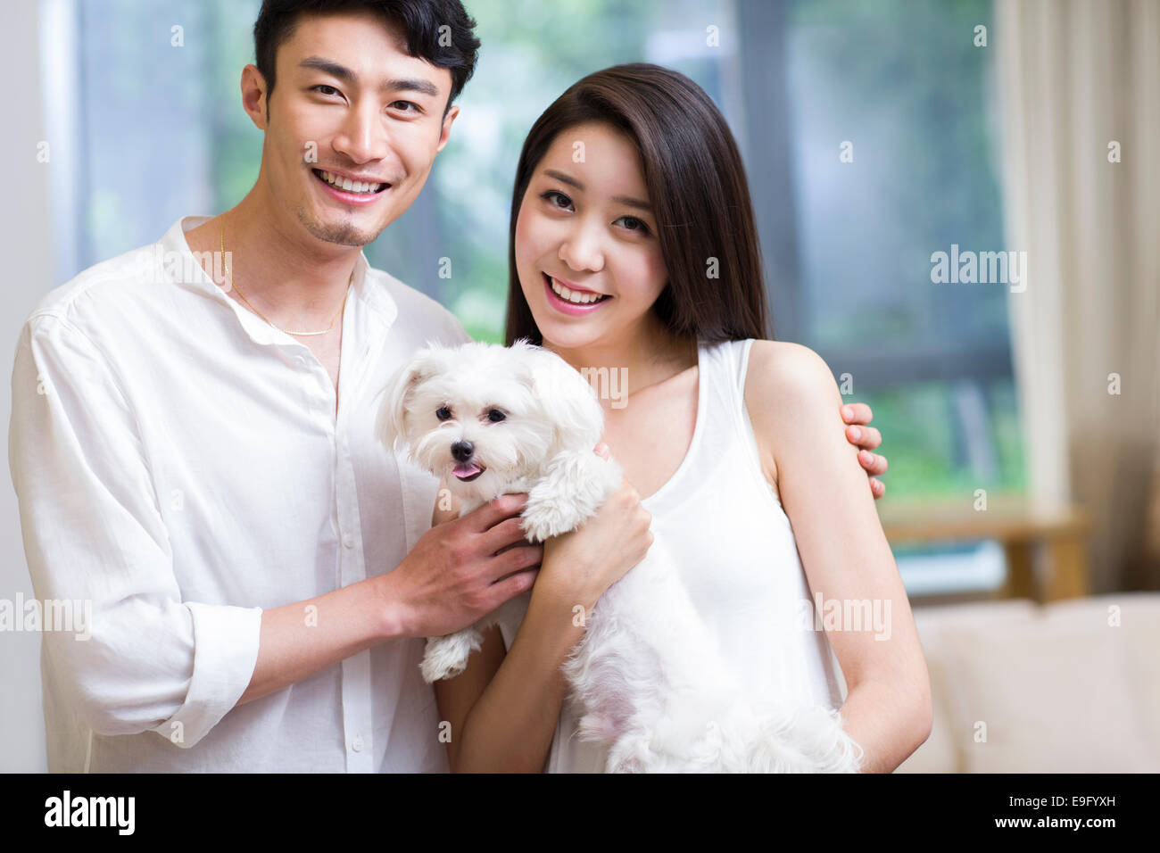 Cheerful young couple and a cute dog Stock Photo - Alamy