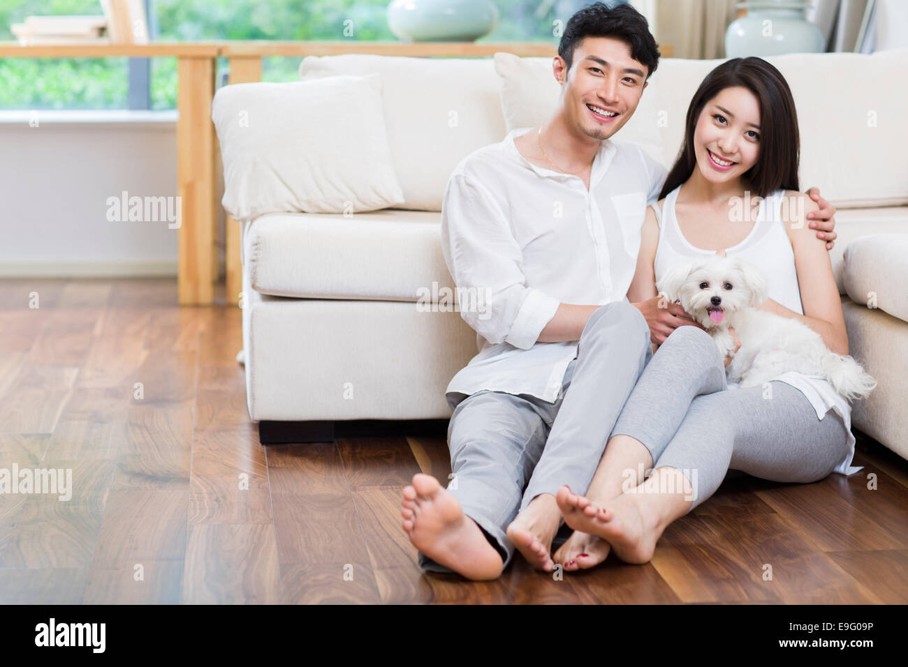 Cheerful young couple and a cute dog Stock Photo