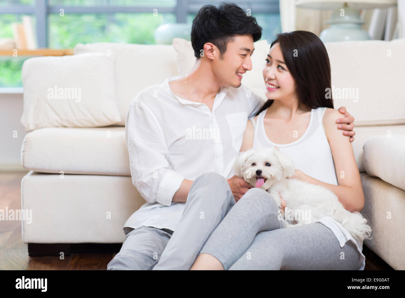 Cheerful young couple and a cute dog Stock Photo - Alamy