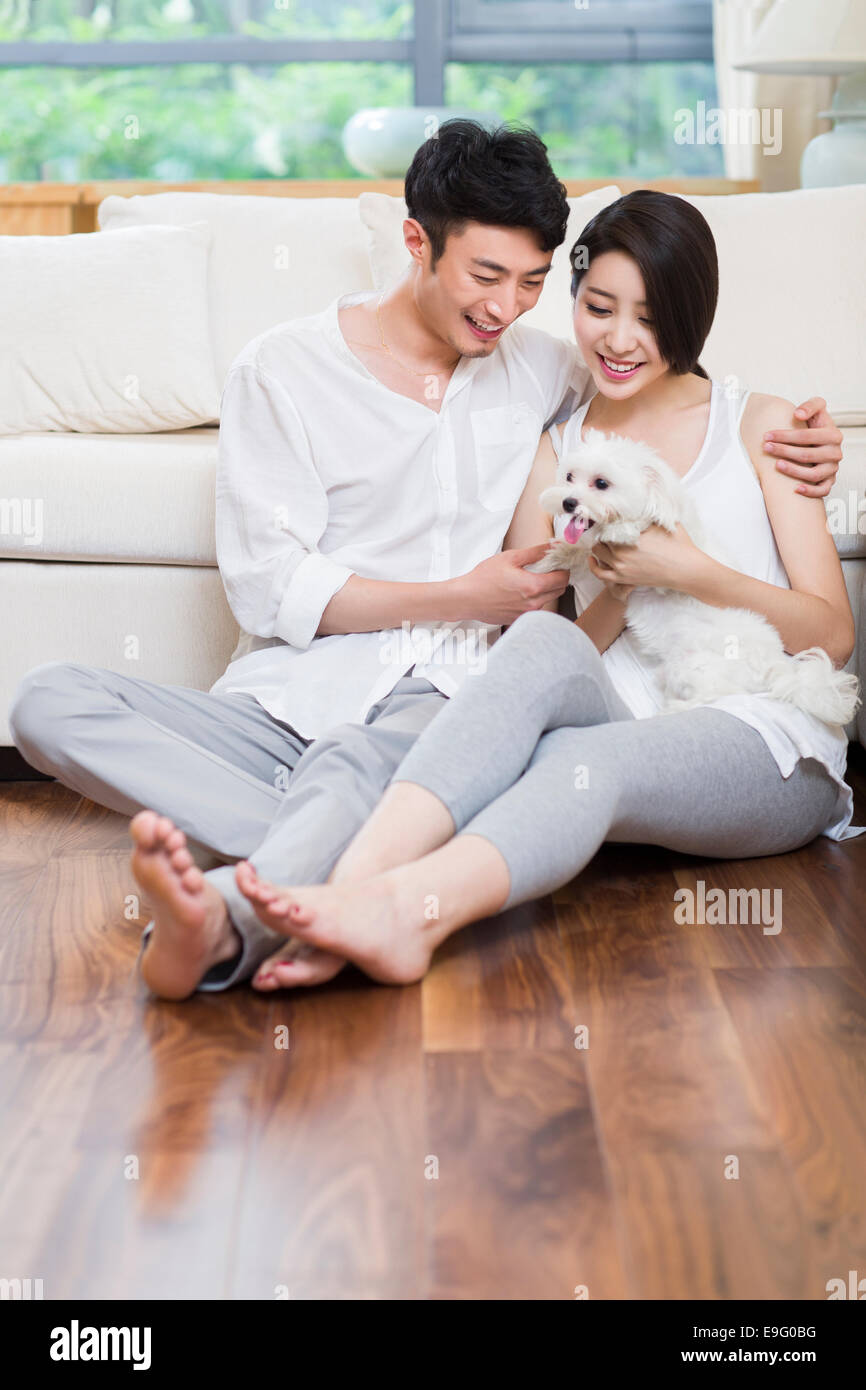 Cheerful young couple and a cute dog Stock Photo