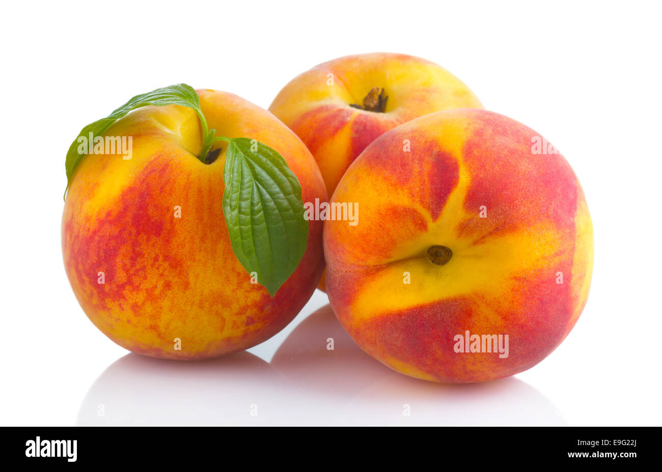 Ripe peach fruits with green leave isolated Stock Photo
