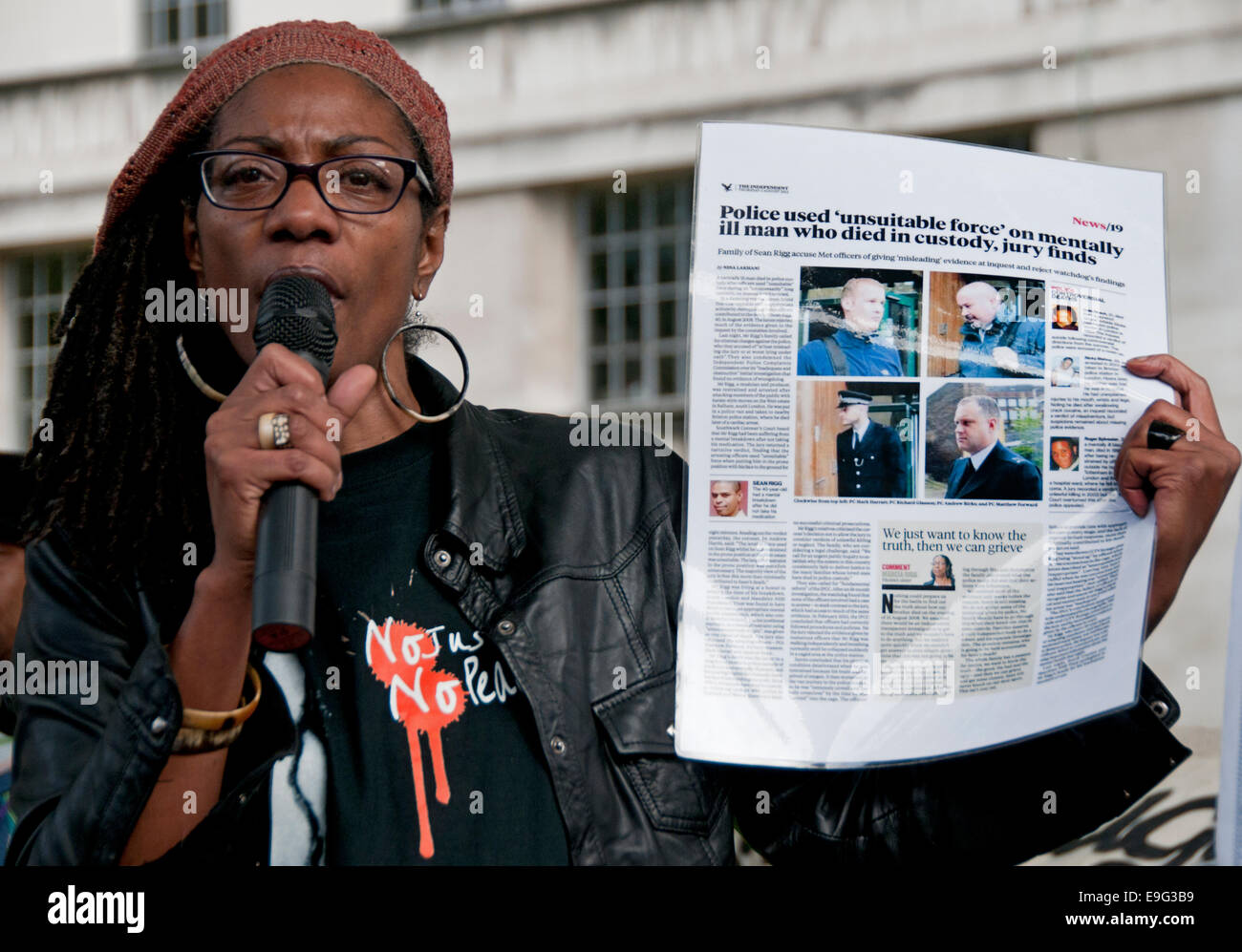 Marcia Rigg holding up article about police who used Unsuitable force on her brother Sean Rigg who died in police Custody. Stock Photo